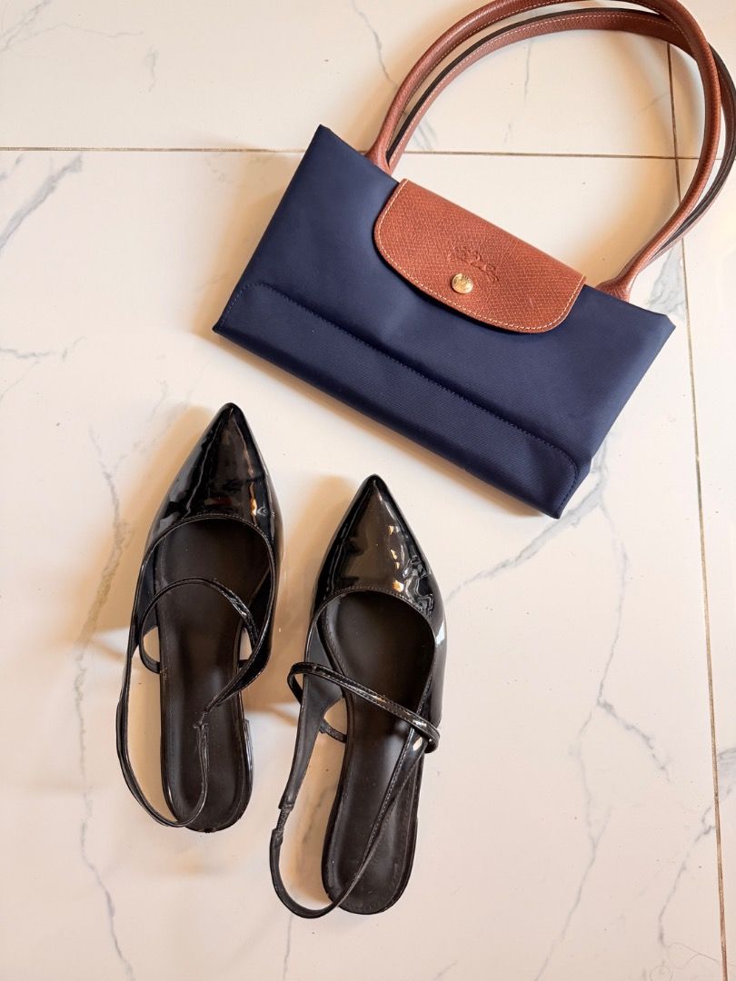 Black Pointed Flats (Category: Flats & Sandals) located in Pasig City. Submitted by alwaysfaevored (Listing ID 1430539742, Image 2). Description: Navy blue Longchamp Le Pliage handbag with brown leather accents. Includes a pair of black pointed-toe flats with slingback straps. The handbag features a flap closure with a button. The flats have a glossy finish. Both items are suitable for everyday use..