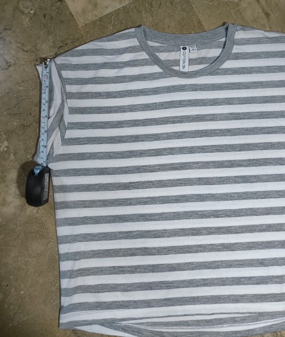 Cotton On Striped T-shirt (Category: Tshirts & Polo Shirts ) located in Caloocan City. Submitted by makyojs (Listing ID 1430545588, Image 3). Description: Gray and white striped t-shirt from Cotton On. Features a round neck and rolled sleeves. Size S. Measurements: 24 inches across the chest, 25 inches in length, and 7 inches sleeve length..