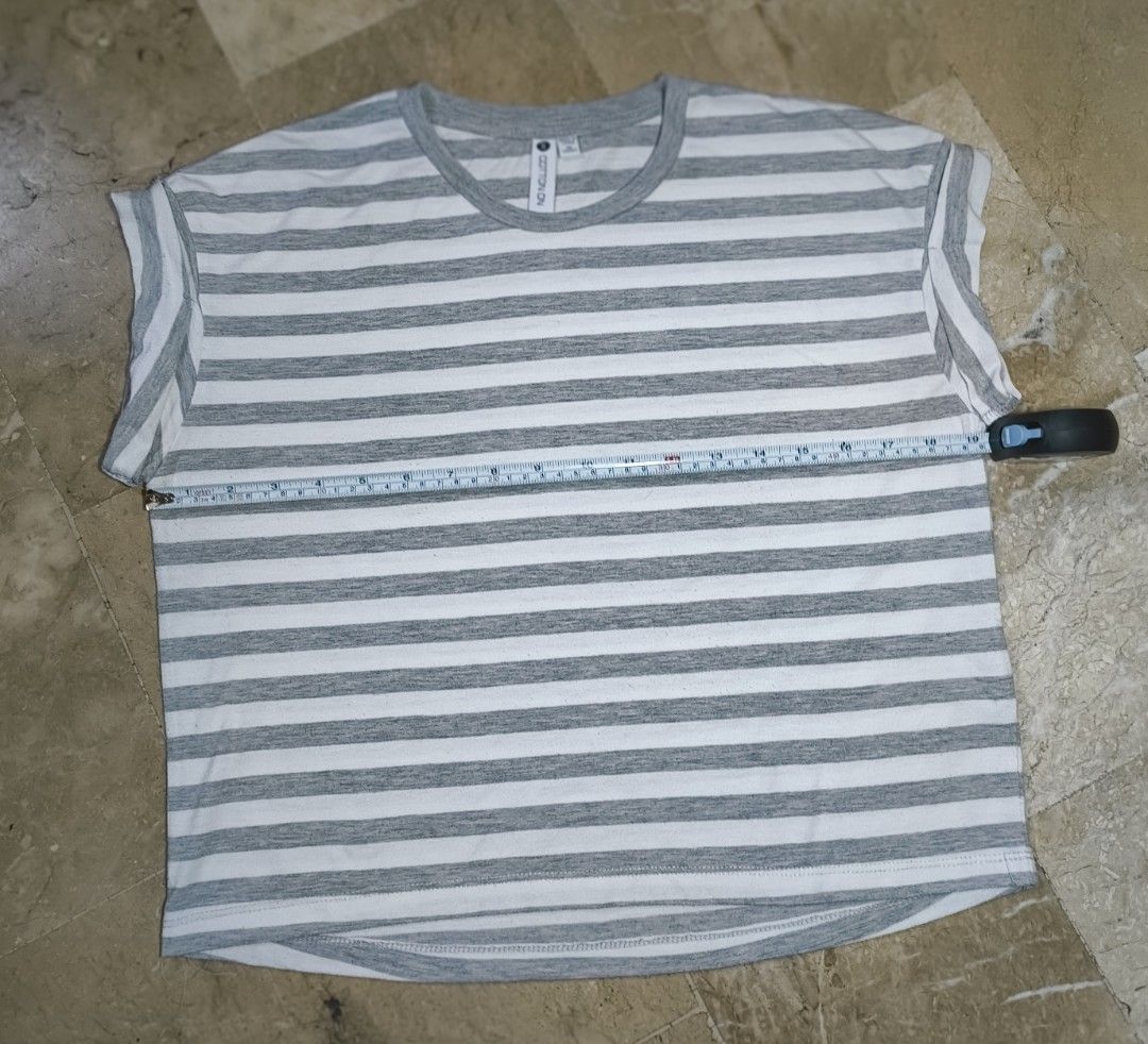 Cotton On Striped T-shirt (Category: Tshirts & Polo Shirts ) located in Caloocan City. Submitted by makyojs (Listing ID 1430545588, Image 2). Description: Gray and white striped t-shirt from Cotton On. Features a round neck and rolled sleeves. Size S. Measurements: 24 inches across the chest, 25 inches in length, and 7 inches sleeve length..