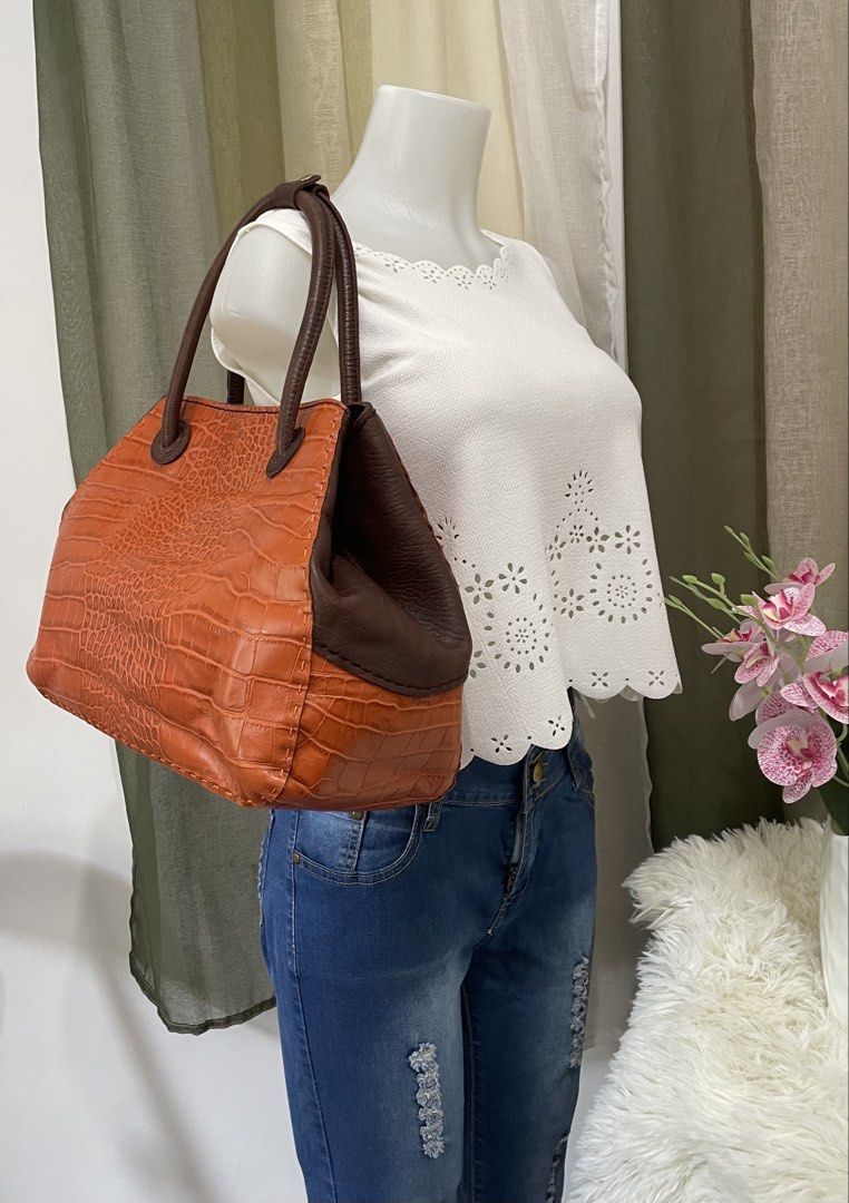 MARKED DOWN! Depride Orange and Brown Convertible Structured Tote (Category: Luxury Bags & Wallets) located in Cabanatuan. Submitted by moraiahraven (Listing ID 1430523105, Image 1). Description: 🤎 **CLASSIC LEATHER CROC-EMBOSSED TOTE** 🤎 ✨ Elegant everyday bag with a timeless look! Perfect for work, errands, or casual chic outfits. Fits 15.6” laptop. 👜 Brand: Depride 👜 Material: Genuine Leather 👜 Color: Burnt Orange (croc-embossed) + Dark B