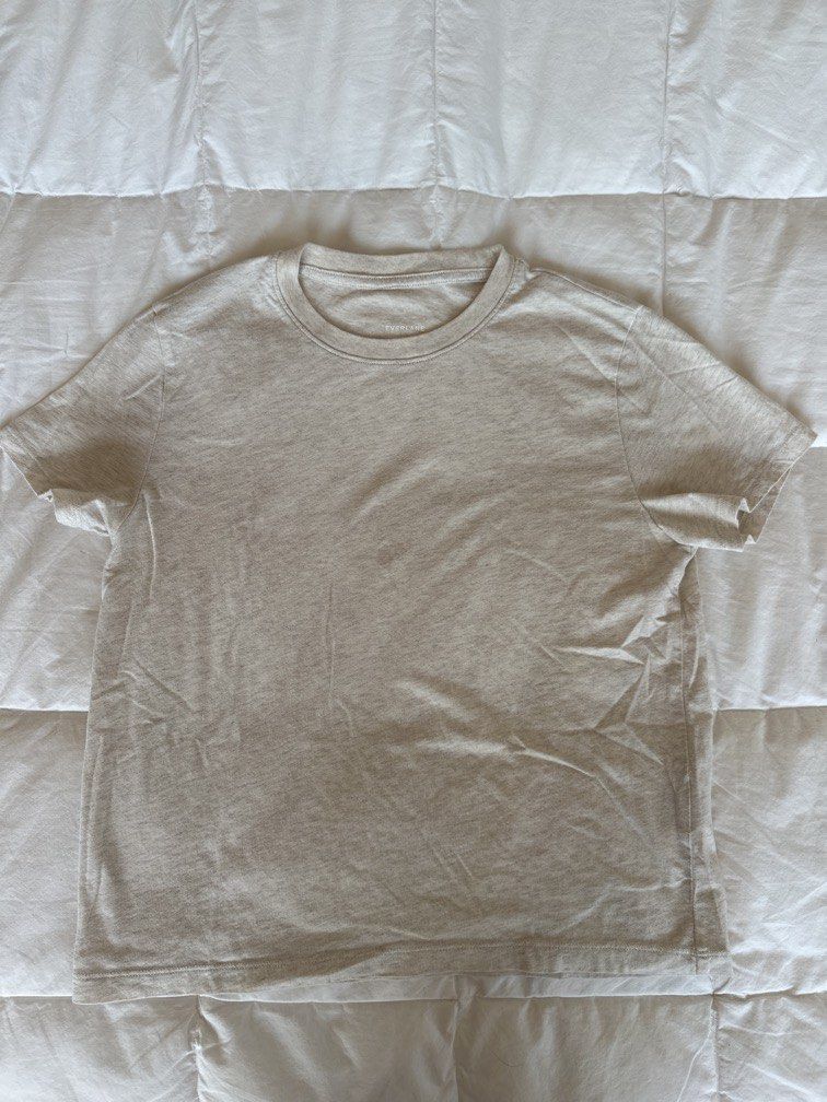 Everlane Crew Neck T-shirt S (Category: Shirts) located in Calamba. Submitted by naturesfield (Listing ID 1430404055, Image 2). Description: Everlane crew neck box cut t-shirt is a classic wardrobe staple. It features a round neckline and short sleeves. The shirt is a light beige color. The size is Small. Made from a soft, comfortable fabric, it's perfect for everyday wear. The Everlane logo is visible on the neckline. Bought for 2500. Slightly n