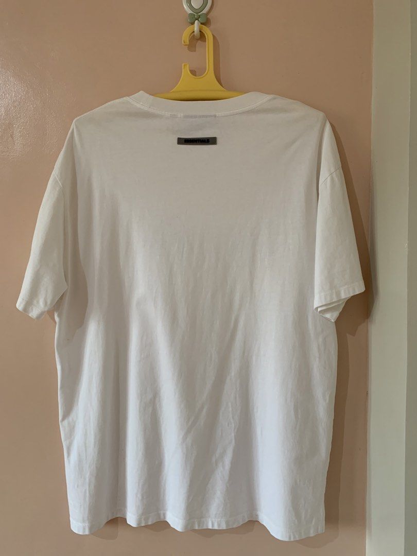 Fear of God Essentials White T-shirt (Category: Tshirts & Polo Shirts ) located in Baler. Submitted by boondocks.thrift (Listing ID 1430410081, Image 3). Description: Dimensions: Length: 30 Width: 23 Color rate: 9/10 Condition: 8/10 Issue: Stains, Broken Embossed Print, Need Wash Claim: ₱300 Dm to purchase #BoondocksAvailable.