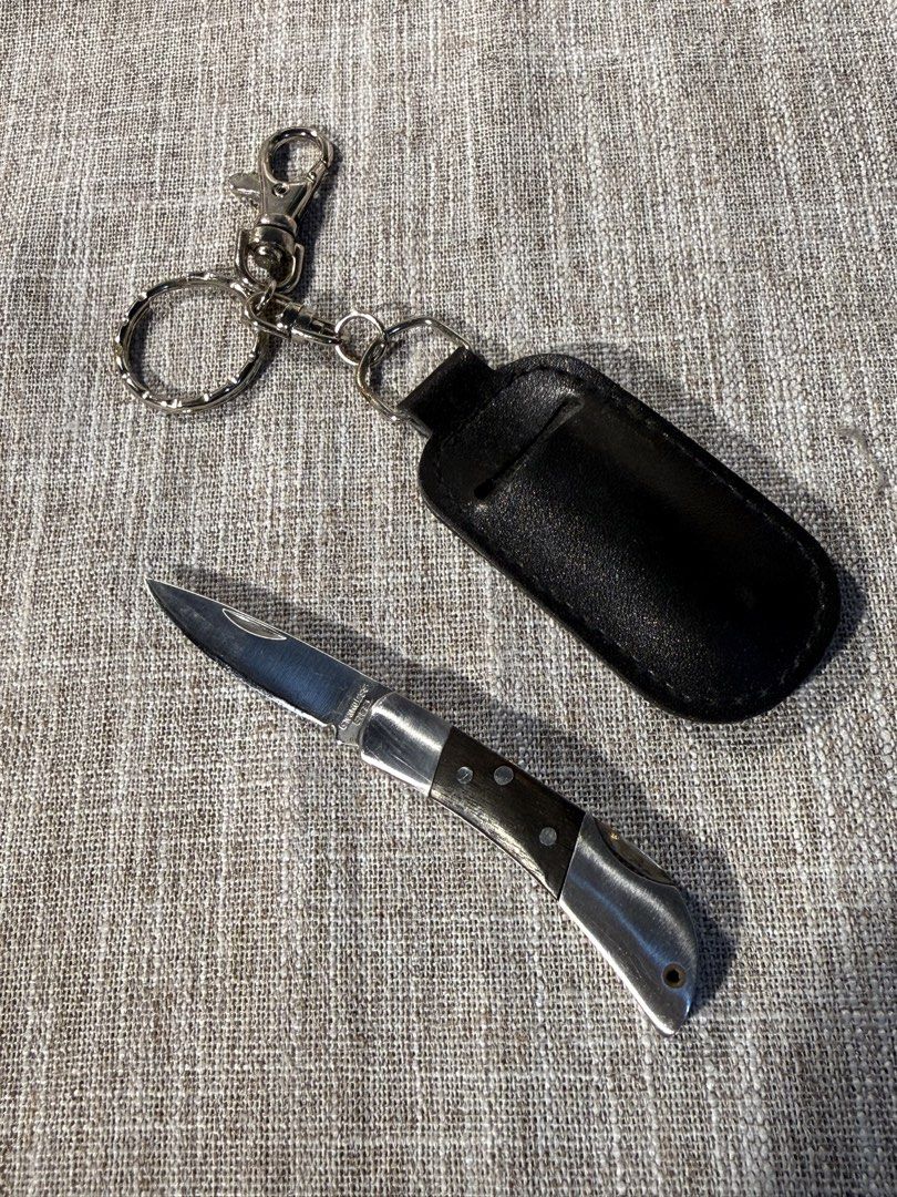 Japan Pocket Knife with Leather Case (Category: Knives & Chopping Boards) located in Valenzuela. Submitted by missp22 (Listing ID 1430567240, Image 1). Description: Pocket knife comes with a black leather case and a keychain. The knife has a silver blade and a dark wooden handle. -Very sharp.