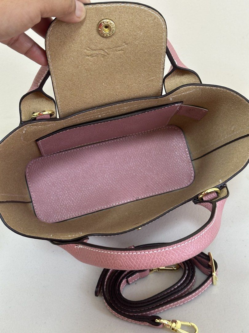 Longchamp Roseau Handbag with Shoulder Strap (Category: Luxury Bags & Wallets) located in Los Banos. Submitted by ditasbautista2329 (Listing ID 1430438277, Image 2). Description: Longchamp Roseau handbag in a lovely pink color. Features a top handle and a detachable shoulder strap for versatile carrying options. The bag has a flap closure with a gold-tone clasp. Interior includes a slip pocket. Made in France. The bag has the Longchamp logo embos
