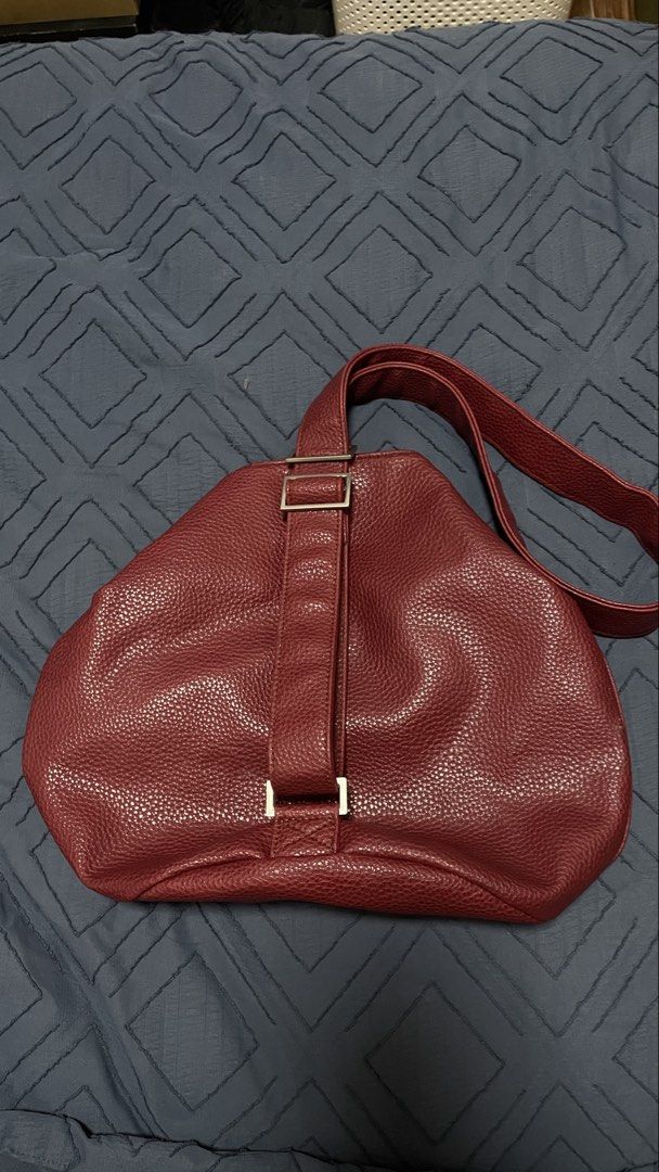 Marithe Francois Girbaud Red Handbag (Category: Luxury Bags & Wallets) located in Santa Rosa. Submitted by southstash.blvd (Listing ID 1430436077, Image 1). Description: Marithe Francois Girbaud handbag in a rich red color. Features a unique shape with a single strap and a buckle detail. The interior is lined with red fabric and includes a zipper. A stylish and functional accessory for everyday use..