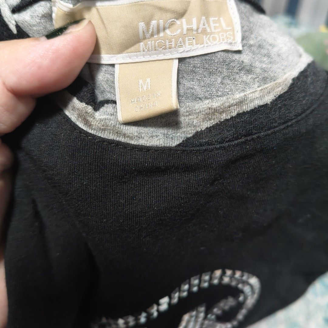 Michael Kors Zebra Print T-shirt (Category: Shirts) located in Manila. Submitted by stuff_finder (Listing ID 1430527876, Image 3). Description: Michael Kors T-shirt features a unique zebra print design. It has a black body with zebra print sleeves and side panels. The front showcases the MK logo embellished with rhinestones. The shirt is a size M..
