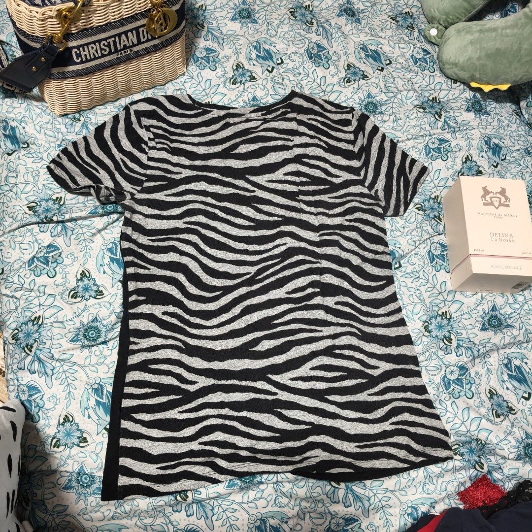 Michael Kors Zebra Print T-shirt (Category: Shirts) located in Manila. Submitted by stuff_finder (Listing ID 1430527876, Image 2). Description: Michael Kors T-shirt features a unique zebra print design. It has a black body with zebra print sleeves and side panels. The front showcases the MK logo embellished with rhinestones. The shirt is a size M..