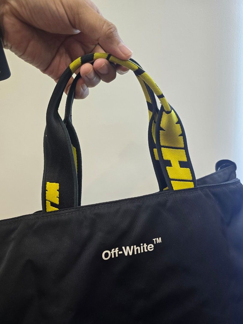 OFF-WHITE Hard Core Black Nylon Tote Bag (Category: Luxury Bags & Wallets) located in Taguig. Submitted by mluxeph (Listing ID 1430467304, Image 2). Description: OFF-WHITE Hard Core Black Nylon Tote Bag Gender: Unisex Material: Nylon and leather Interior: One card slot, one zip pocket and one main compartment Measurements: 14.6”L X 4”W X 16”H Handle Drop: 5.5" Hardware: Silver tone Inclusions: Original dust bag, removable strap and care card.