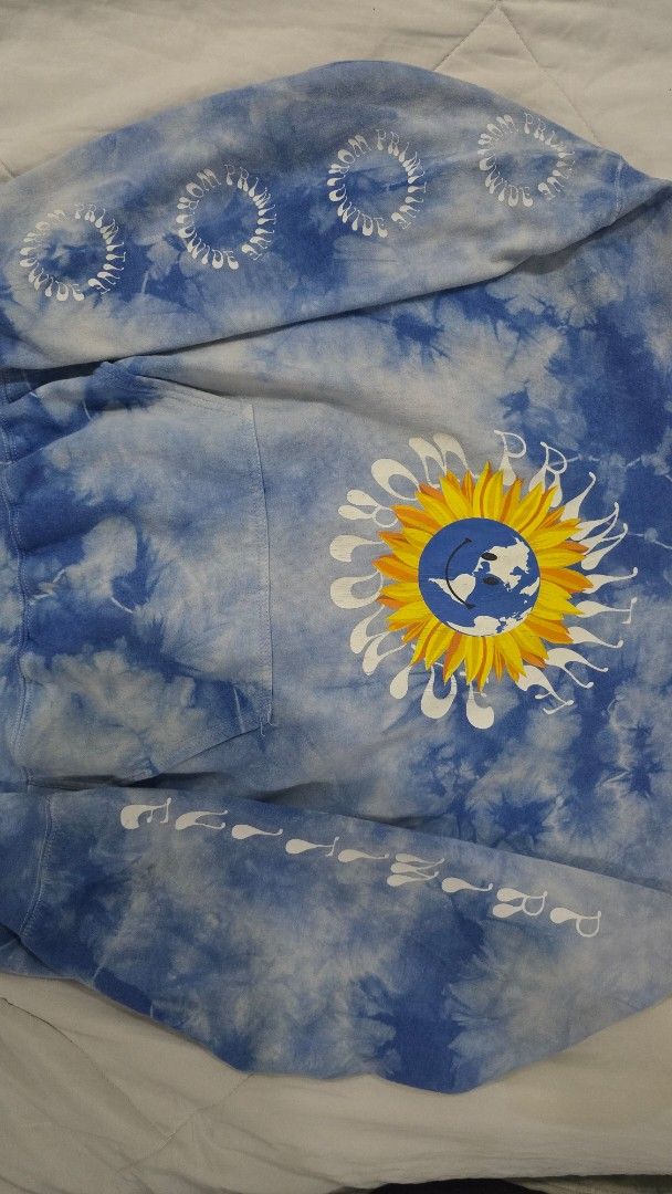Primitive Worldwide Tie-Dye Hoodie (Category: Hoodies) located in Cainta. Submitted by masnes (Listing ID 1430536207, Image 2). Description: Primitive Worldwide hoodie features a unique tie-dye design with a sunflower graphic on the front. The sleeves have additional graphics. It has a hood and a front pocket. The hoodie is blue and white in color. (Size Large semi XL, Boxy) -23.5 Width -25.5 Length Issue: -No Lace -Minimal cracks -Faded Print Ta