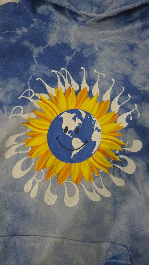 Primitive Worldwide Tie-Dye Hoodie (Category: Hoodies) located in Cainta. Submitted by masnes (Listing ID 1430536207, Image 3). Description: Primitive Worldwide hoodie features a unique tie-dye design with a sunflower graphic on the front. The sleeves have additional graphics. It has a hood and a front pocket. The hoodie is blue and white in color. (Size Large semi XL, Boxy) -23.5 Width -25.5 Length Issue: -No Lace -Minimal cracks -Faded Print Ta