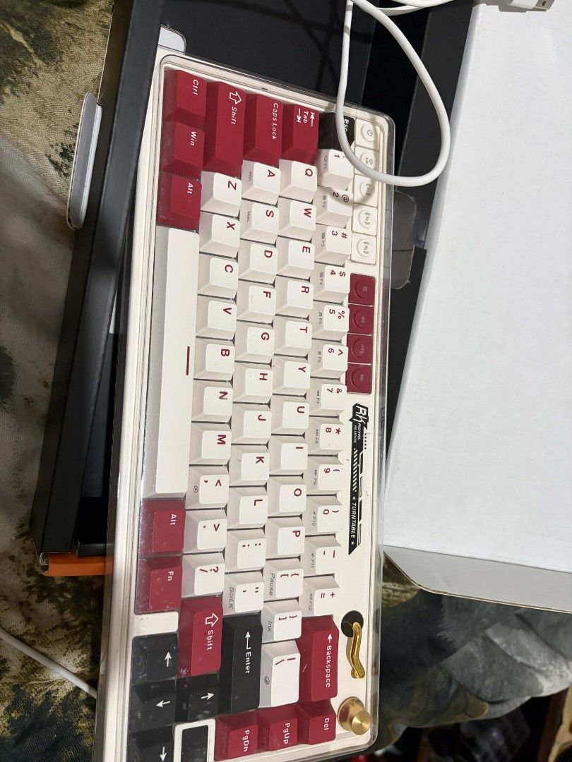 RK M65 Mechanical Keyboard (Category: Computer Keyboard) located in Legazpi City. Submitted by ThriftersTop.Picks (Listing ID 1430565733, Image 3). Description: Slightly Used RK M65 mechanical keyboard with a white and red keycap set. The keyboard has a 65% layout. Includes the original box and a cable. The keyboard has a gold-colored accent on the side. The keycaps are a mix of white and red. Bought for 3100 online. Would like to sell because i 