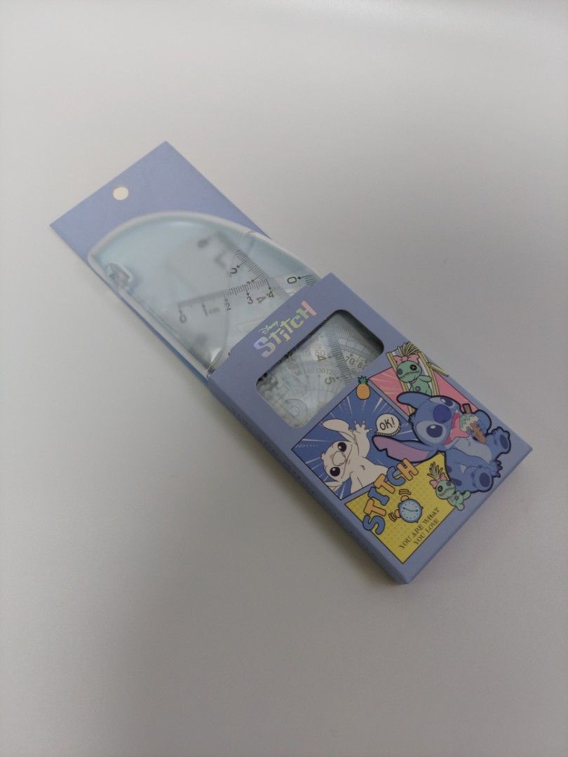 Stitch Ruler Set (Category: Stationery & School Supplies) located in Quezon City. Submitted by robyns.closet.ph (Listing ID 1430468941, Image 1). Description: Stitch ruler set includes a protractor, two triangles, and a ruler. The set comes in a light blue case with Stitch graphics. The rulers are transparent with black markings. The set is ideal for school or office use..