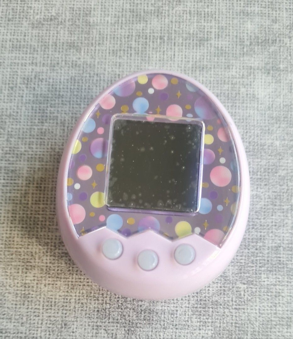Tamagotchi Mix (M!x) Melody Land Virtual Pet Toy Bandai Namco (Category: Interactive Toys) located in Singapore. Submitted by rynexxa (Listing ID 1430499087, Image 3). Description: Buttons, display and sound all working perfectly. Light scratches on unit but no cracks Screen protector on is a bit bubbly as shown and does not affect visual. All lands unlocked. Your choice to reset or continue. 99999 Gotchi pts. Cross bred with Anniversary Gift M!x