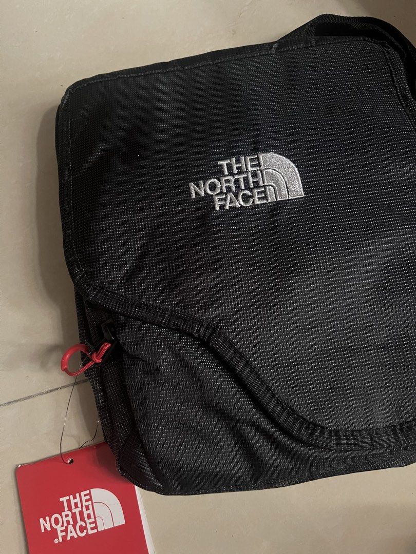 The North Face Tellus Messenger Bag (Category: Sling Bags) located in Manila. Submitted by mstenj (Listing ID 1430511898, Image 1). Description: North Face Tellus messenger bag in black. Features the North Face logo on the front. Includes original tags with details such as the model number NM06106 and the color K black. Made in Vietnam. The tag also indicates a price of ¥17,850..