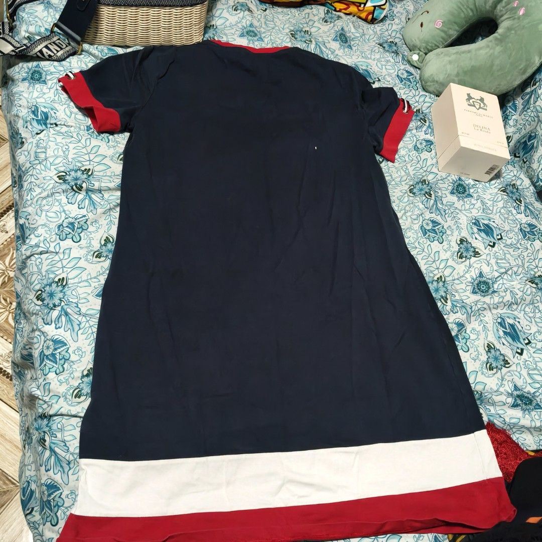 Tommy Hilfiger Navy Dress (Category: Dresses) located in Manila. Submitted by stuff_finder (Listing ID 1430527586, Image 3). Description: Navy dress from Tommy Hilfiger with red and white accents. Features a round neckline and short sleeves with red cuffs. The dress has a white band at the bottom, followed by a red band. The Tommy Hilfiger logo is visible on the chest. The dress is a size L..