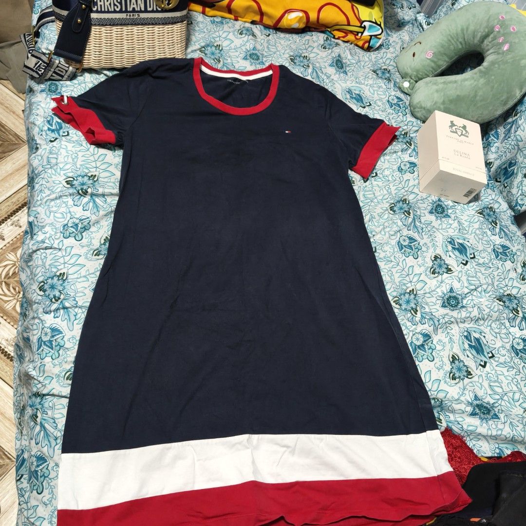 Tommy Hilfiger Navy Dress (Category: Dresses) located in Manila. Submitted by stuff_finder (Listing ID 1430527586, Image 1). Description: Navy dress from Tommy Hilfiger with red and white accents. Features a round neckline and short sleeves with red cuffs. The dress has a white band at the bottom, followed by a red band. The Tommy Hilfiger logo is visible on the chest. The dress is a size L..