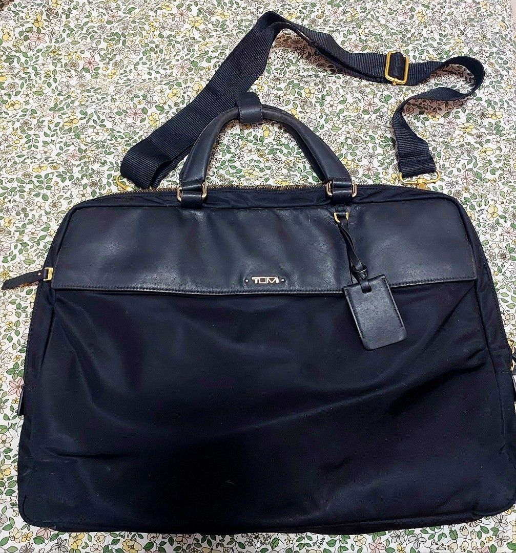 Tumi Black Briefcase with Shoulder Strap (Category: Briefcases) located in Manila. Submitted by gflo72345 (Listing ID 1430561285, Image 1). Description: can fit 15in laptop authentic generic strap only good condition! minor scratches on leather with small ink blots in interior pocket.