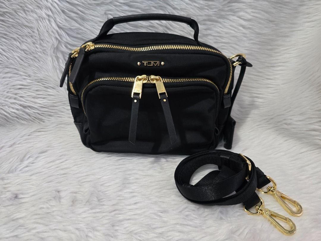 Tumi Tamy Crossbody Bag (Category: Luxury Bags & Wallets) located in Manila. Submitted by forever28mnl (Listing ID 1430474196, Image 3). Description: Tumi Tami Crossbody Color: Black Guaranteed Original. Bought in USA Used only twice 7" x 8.25" x 2.25" Two-way top-zip closure Top carry handle; removable, adjustable crossbody strap Exterior two-way zip pocket; back magnetic-snap pocket; luggage tag Interior zip pocket with Tumi Tracer; key leash .