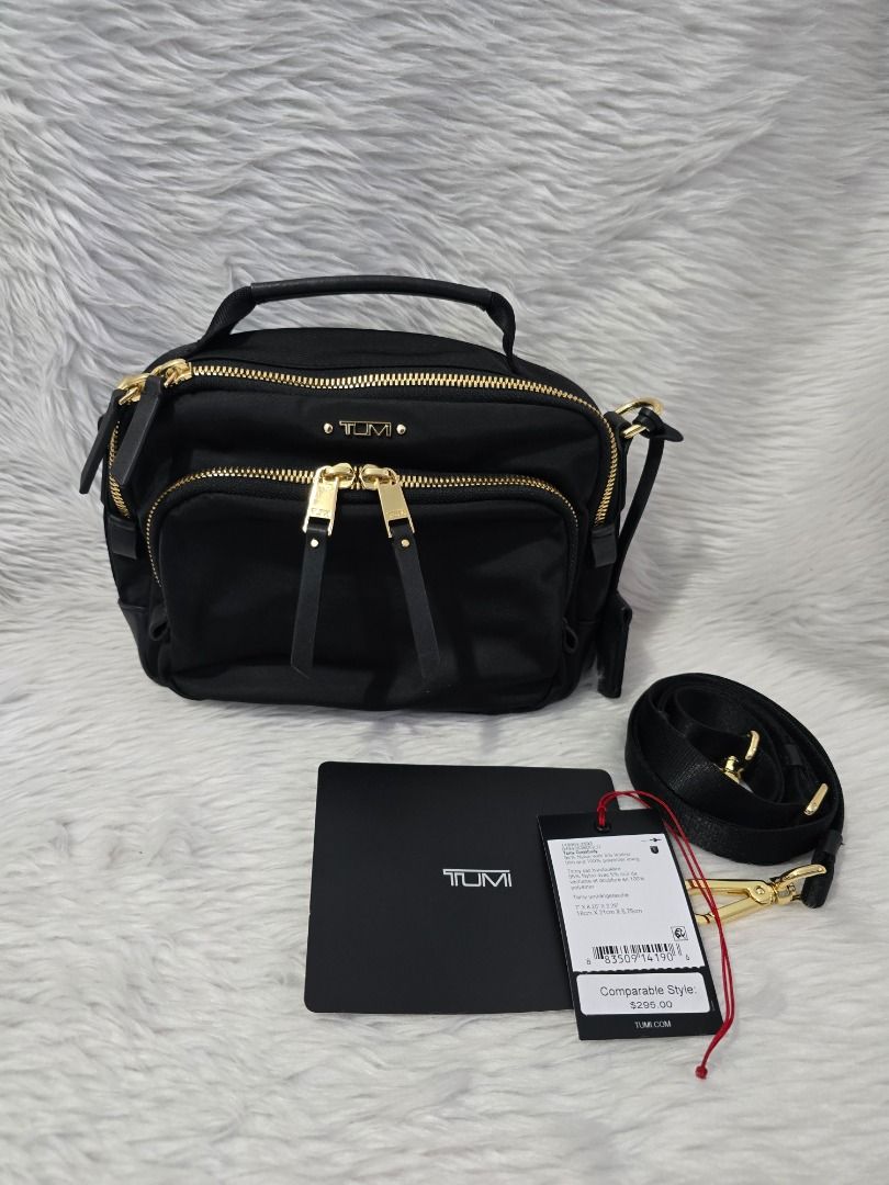 Tumi Tamy Crossbody Bag (Category: Luxury Bags & Wallets) located in Manila. Submitted by forever28mnl (Listing ID 1430474196, Image 2). Description: Tumi Tami Crossbody Color: Black Guaranteed Original. Bought in USA Used only twice 7" x 8.25" x 2.25" Two-way top-zip closure Top carry handle; removable, adjustable crossbody strap Exterior two-way zip pocket; back magnetic-snap pocket; luggage tag Interior zip pocket with Tumi Tracer; key leash .