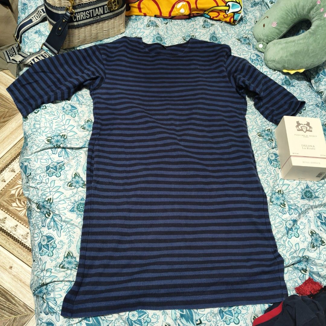 Uniqlo Striped Dress (Category: Dresses) located in Manila. Submitted by stuff_finder (Listing ID 1430525323, Image 2). Description: Dress features a navy and black striped pattern. It has a round neckline and three-quarter sleeves. The tag indicates it is made in Vietnam. fit until large.