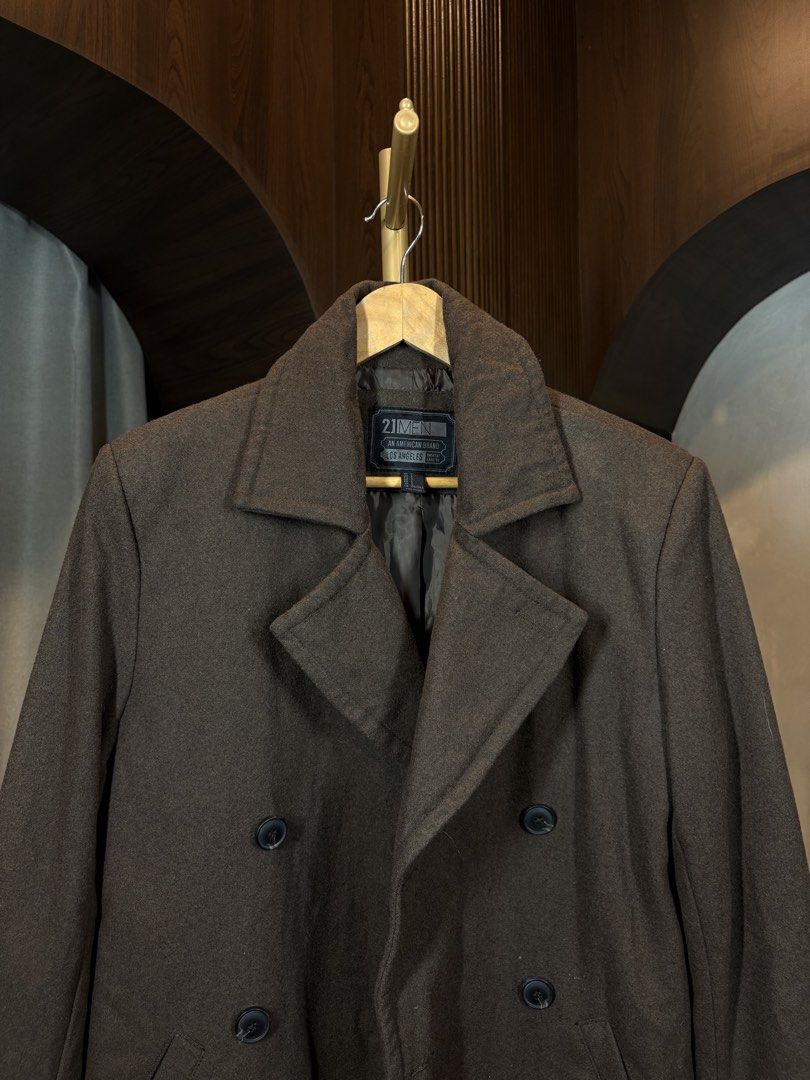 21 MEN Double-Breasted Coat (Category: Coats, Jackets and Outerwear) located in Manila. Submitted by ccuadralaw (Listing ID 1430676722, Image 2). Description: Double-breasted coat from 21 MEN features a classic design. It has a dark brown color and a notched lapel. The coat has two rows of buttons and two front pockets. The lining is made of polyester and wool. The size is S. Made in China..