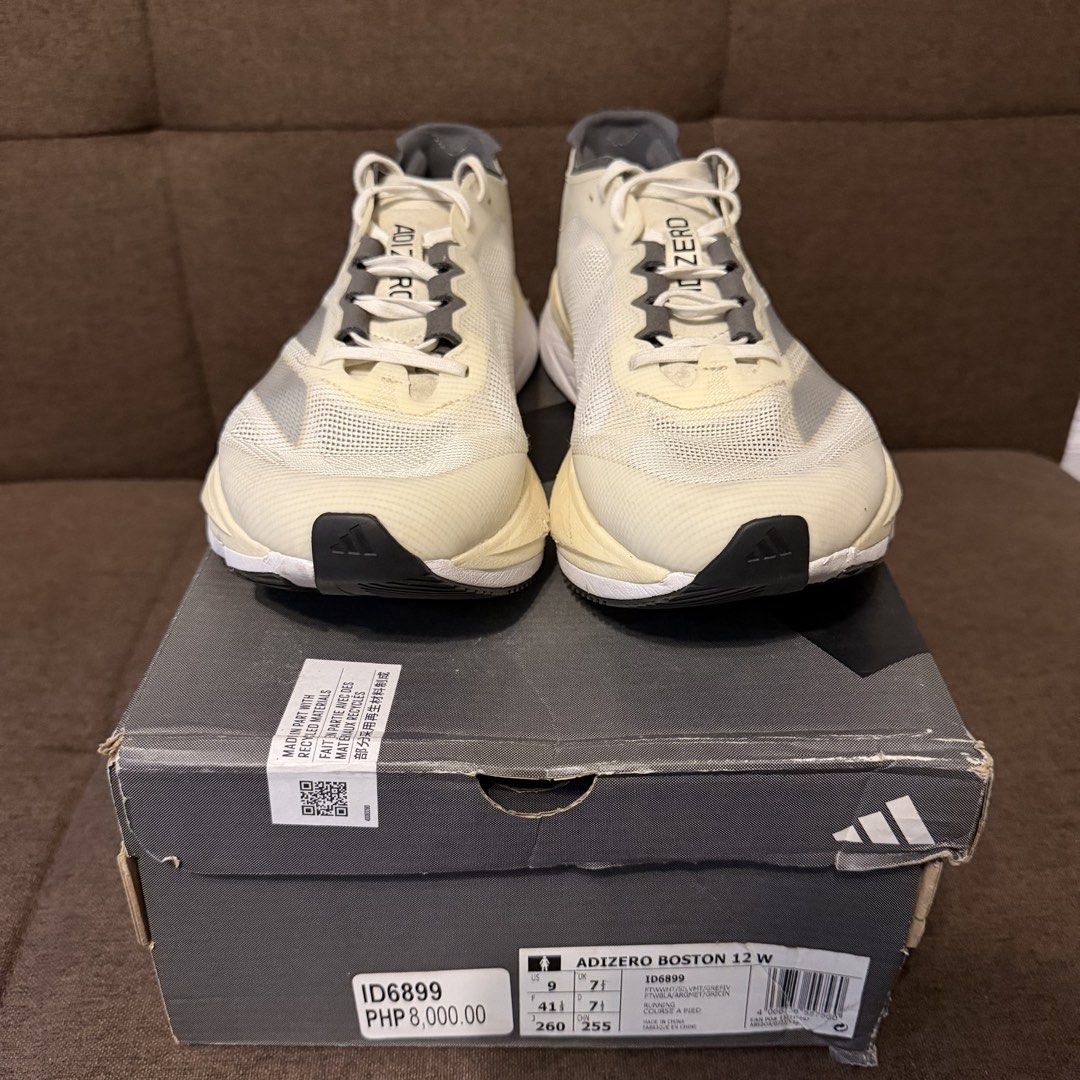 adidas adizero Boston 12 W (Category: Sneakers) located in Pasay City. Submitted by joshwhacker (Listing ID 1430773053, Image 2). Description: Adidas Adizero Boston 12 W running shoes. Features a cream and grey colorway with the Adidas logo on the side. The box indicates a size 9 US, 7 UK, and 260 JP. The shoes have a Lightstrike Pro midsole and Continental outsole. The shoes are in the original box (slightly damaged). .
