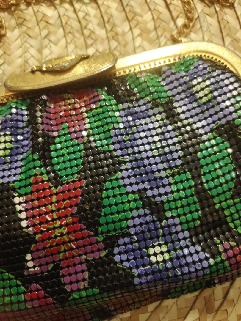 Arton Floral Clutch with Chain (Category: Clutches) located in Alaminos. Submitted by adornaura (Listing ID 1430611971, Image 2). Description: Elegant clutch bag by Arton, featuring a vibrant floral design. It has a gold-toned frame and a detachable chain strap. The interior is lined with black fabric and includes a zippered pocket. The bag's exterior showcases a mesh-like pattern with a mix of colors, adding a touch of vintage charm..