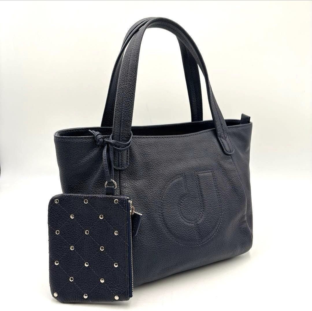 Authentic Charles Jourdan Paris Tote Bag (Category: Tote Bags) located in Pasig City. Submitted by khaid (Listing ID 1430636489, Image 2). Description: Black tote bag with a matching wallet. The bag features a large embossed logo on the front and has two shoulder straps. The wallet is a small, square design with a studded pattern. Pink Sanitizer not included.