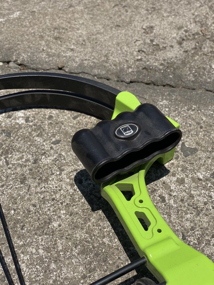 Bear Archery Compound Bow (Category: Other Sports Equipment and Supplies) located in Los Banos. Submitted by ejb418 (Listing ID 1430688574, Image 3). Description: Compound bow features a vibrant green frame with black accents. The brand name "Bear" is visible on the bow. It includes a string and other components. It is suitable for archery enthusiasts..