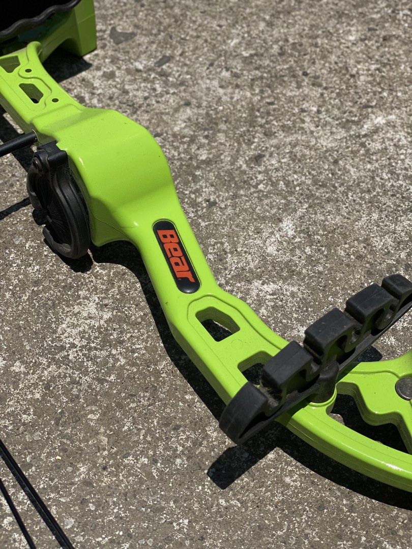Bear Archery Compound Bow (Category: Other Sports Equipment and Supplies) located in Los Banos. Submitted by ejb418 (Listing ID 1430688574, Image 2). Description: Compound bow features a vibrant green frame with black accents. The brand name "Bear" is visible on the bow. It includes a string and other components. It is suitable for archery enthusiasts..