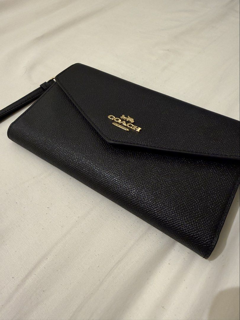 Coach Travel Wallet (Category: Luxury Bags & Wallets) located in San Pedro. Submitted by angelona123456 (Listing ID 1430760500, Image 3). Description: - Coach Travel Wallet - Black envelope design - Features wrist strap - Gold Coach logo - Ideal for travel and everyday use - With five card slots, inside zip coin pocket and slots perfect for passport and boarding pass - Item is good as new - RFS: Seldom used - Please make an offer if interested .