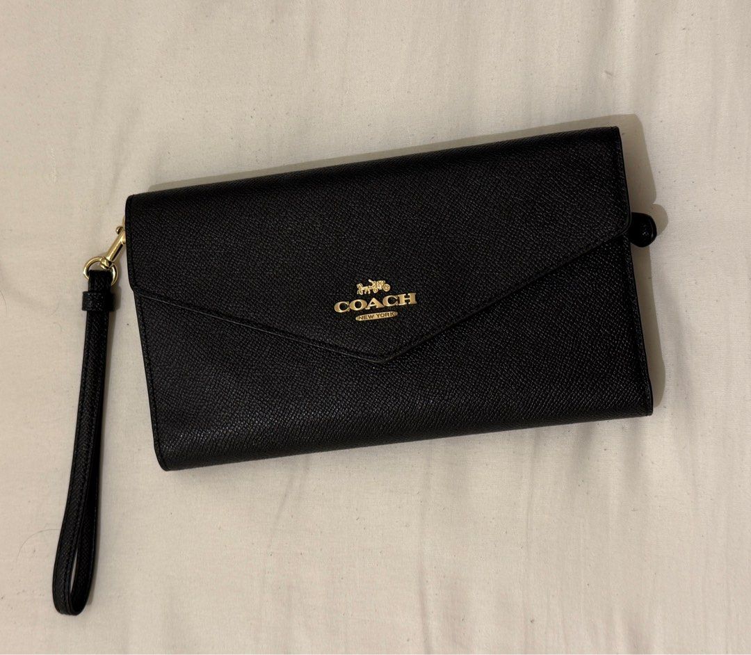 Coach Travel Wallet (Category: Luxury Bags & Wallets) located in San Pedro. Submitted by angelona123456 (Listing ID 1430760500, Image 2). Description: - Coach Travel Wallet - Black envelope design - Features wrist strap - Gold Coach logo - Ideal for travel and everyday use - With five card slots, inside zip coin pocket and slots perfect for passport and boarding pass - Item is good as new - RFS: Seldom used - Please make an offer if interested .