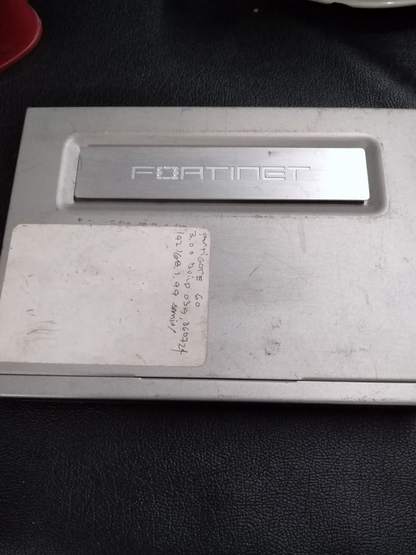 Fortinet FortiGate-60 Router (Category: Networking) located in Manila. Submitted by maybonifacio (Listing ID 1430684654, Image 2). Description: Fortinet FortiGate-60 router. Features multiple ports including WAN, USB, and internal ports. The device has a DC 12V input and includes a console port. The product name and serial number are visible on the device. Made in China..