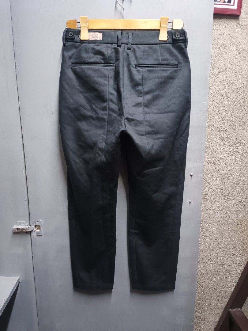 Initial Gentleman Ankle Length Tapered Slim Pants (Category: Trousers) located in Dasmarinas. Submitted by jessputrages (Listing ID 1430762130, Image 2). Description: These Initial Gentleman pants feature an ankle-length, tapered slim fit. The pants are a dark color, possibly black or a very dark grey. The tag indicates the model is P07. The material composition includes polyester, cotton, and spandex. The pants have a button and zipper closure. 