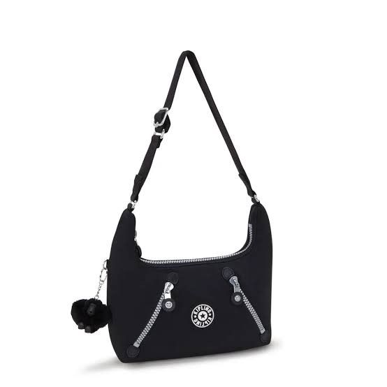 Kipling Nikki Shoulder Bag - Rapid Black (Category: Shoulder Bags) located in Davao. Submitted by jilly07 (Listing ID 1430613260, Image 1). Description: Kipling Nikki shoulder bag is in black. It features a main compartment with a zipper closure, and an adjustable shoulder strap. The bag includes a small Kipling monkey charm. It has a front zipper pocket and a Kipling logo patch. The bag is shown being worn over the shoulder. In excellent conditi