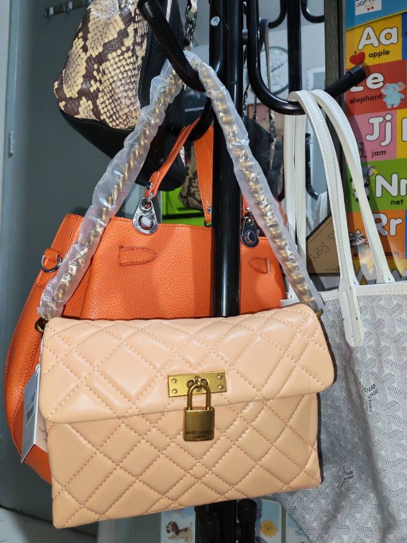 Kurt Geiger London - CrossBody Bag (Category: Luxury Bags & Wallets) located in Manila. Submitted by jewfindshop (Listing ID 1430766607, Image 2). Description: Kurt Geiger London handbag / crossbody bag features a quilted design with a gold-tone lock closure. It includes a detachable strap and a chain strap. The interior is black. The bag comes with a dust bag and tags. The colour is a light peach..