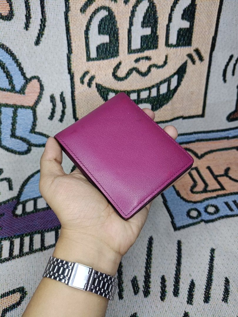 Louis Quatorze Leather Bifold Wallet (Category: Wallets & Card Holders) located in Taguig. Submitted by handpickedreplay (Listing ID 1430699238, Image 3). Description: Louis Quatorze Small Bifold Wallet 👽 It features a vibrant pink exterior and a matching interior. The wallet has multiple card slots, a clear ID window, and a bill compartment. The Loewe logo is subtly displayed on the front. Minimal sign of usage or fadings but rubber lining stil