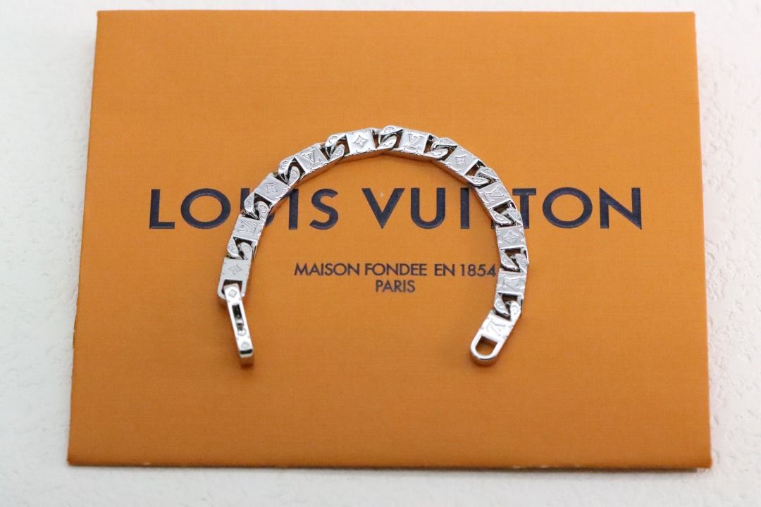 Louis Vuitton Silver Bracelet (Category: Bracelets) located in Pateros City. Submitted by silvercat-dab8ef (Listing ID 1430688151, Image 2). Description: Silver bracelet from Louis Vuitton. The bracelet features a chain link design with the Louis Vuitton logo engraved on each link. It has a clasp closure. The bracelet is displayed on a Louis Vuitton box..