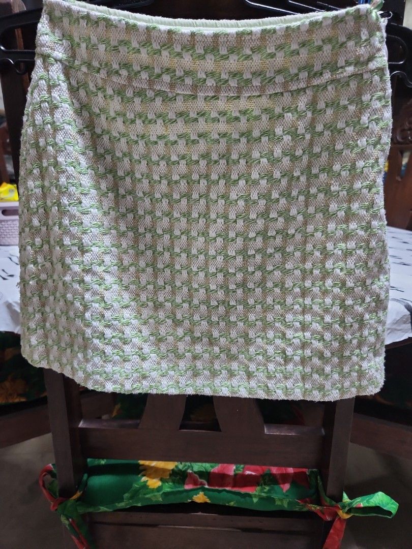 Mango Green and White Tweed skirt (Category: Blouses) located in Makati City. Submitted by fairytale8888 (Listing ID 1430726699, Image 1). Description: Authentic Top from MNG features a textured green and white pattern. The inside lining is a light green color. The tag indicates it is made in China. The fabric has a woven appearance..