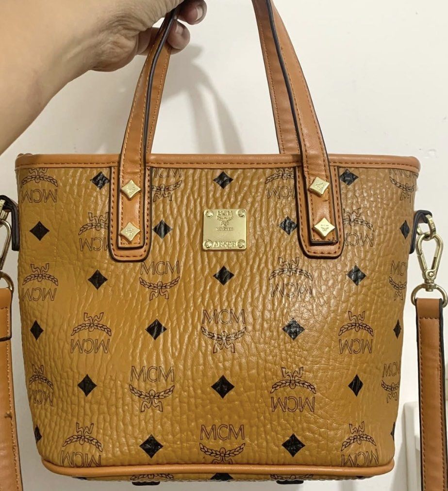 MCM sling bag (Category: Luxury Bags & Wallets) located in Makati City. Submitted by shemiyu (Listing ID 1430744725, Image 2). Description: MCM Cognac Mini Tote with sling Source: Korea Height: 17 cm Width: 25 cm.