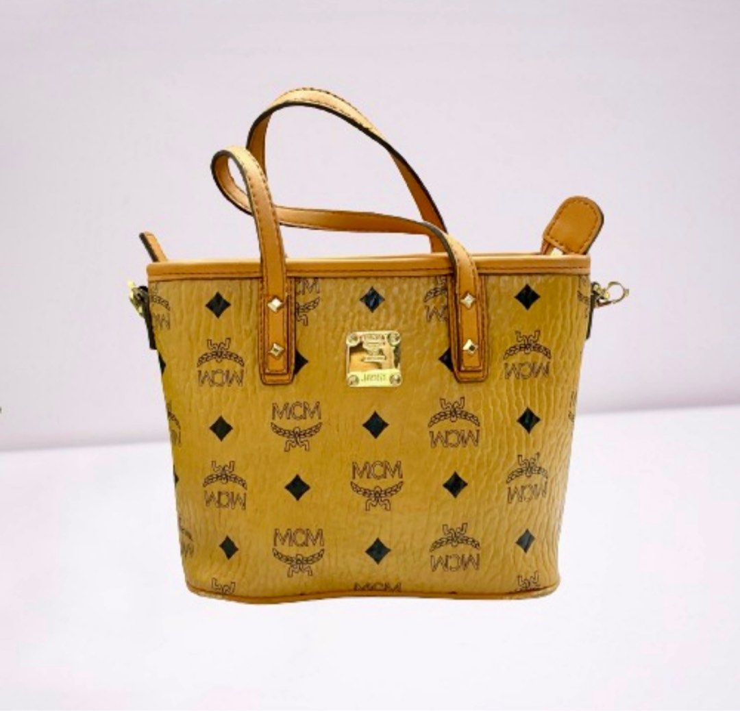 MCM sling bag (Category: Luxury Bags & Wallets) located in Makati City. Submitted by shemiyu (Listing ID 1430744725, Image 1). Description: MCM Cognac Mini Tote with sling Source: Korea Height: 17 cm Width: 25 cm.