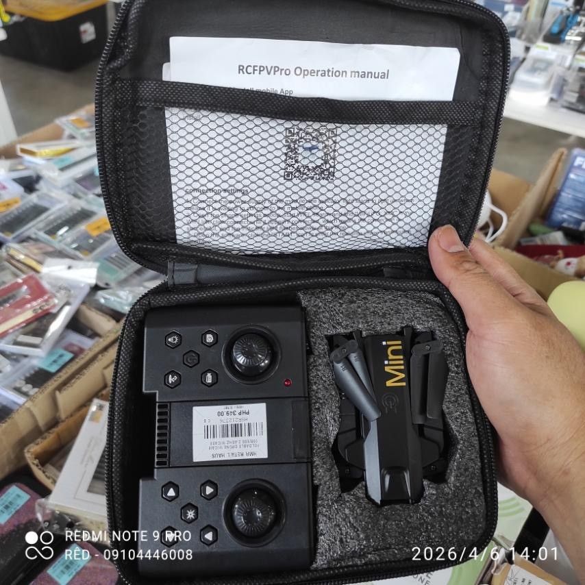 Mini Drone with Remote Control (Category: Drones) located in Manila. Submitted by red_finders (Listing ID 1430790685, Image 1). Description: Mini drone comes with a remote control and operation manual. It is stored in a black carrying case. The drone is black with gold lettering that says "Mini". The remote control has multiple buttons and joysticks. The operation manual is for RCFPVPro..
