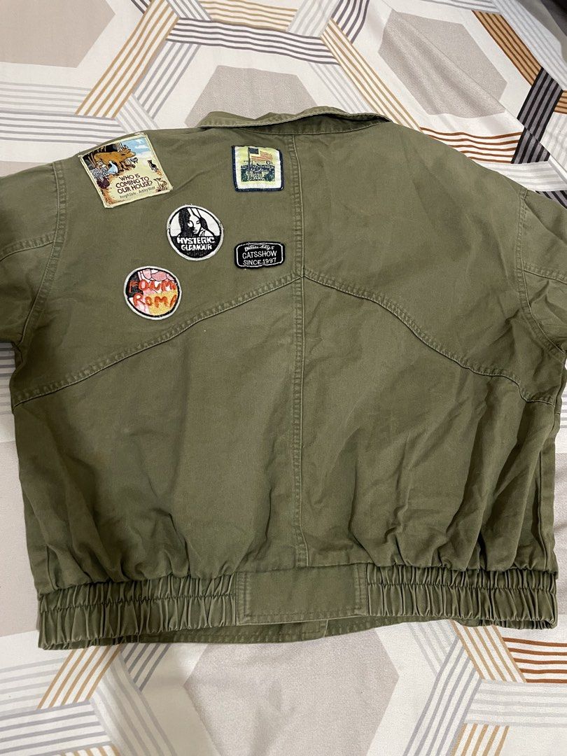Olive Green Patchwork Jacket (Category: Coats, Jackets and Outerwear) located in Tanza. Submitted by declutchedd_dd (Listing ID 1430715171, Image 3). Description: -rfs: decluttering -no issue - color rate 10/10 - Olive green jacket - Button closure - Two front pockets - Patches on the back - Collared neckline - Elasticated hem and cuffs - Relaxed fit - White buttons with silver rim.