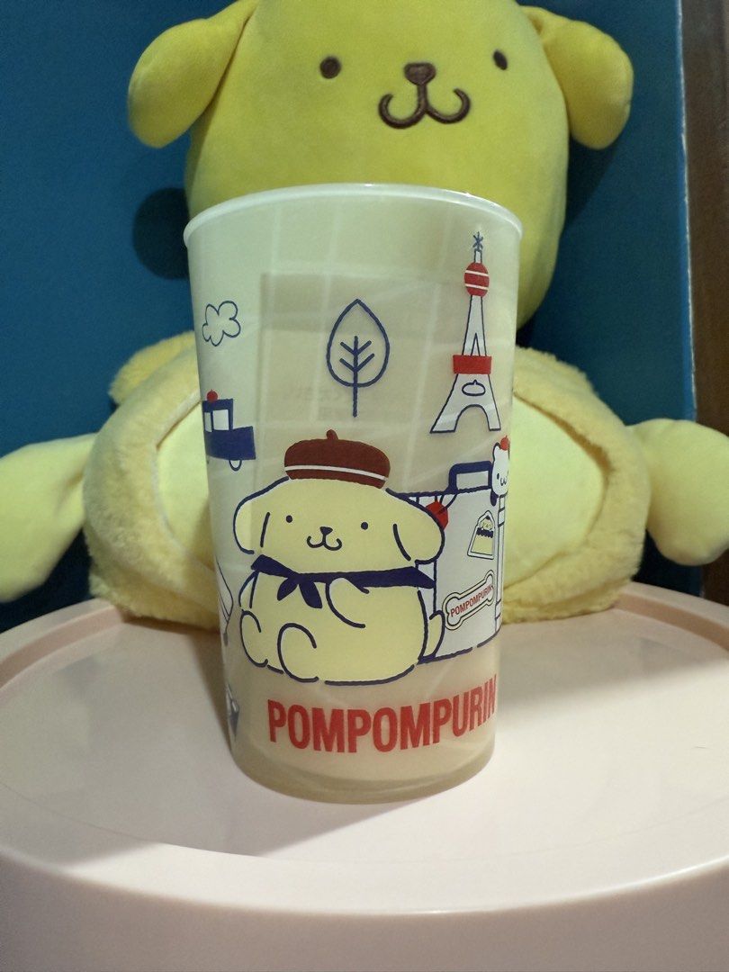 Sanrio Pompompurin plastic cup (Category: Water Bottles & Tumblers) located in Makati City. Submitted by karabelle19923 (Listing ID 1430659659, Image 1). Description: - Pompompurin plastic tumbler with travel-themed illustrations. - Features iconic landmarks and designs. - Official Sanrio licensed product. - Ideal for Pompompurin fans. - Cute and functional drinkware. Size: Approximately 8cm in diameter x 12cm in length Capacity…420ml Material…PP