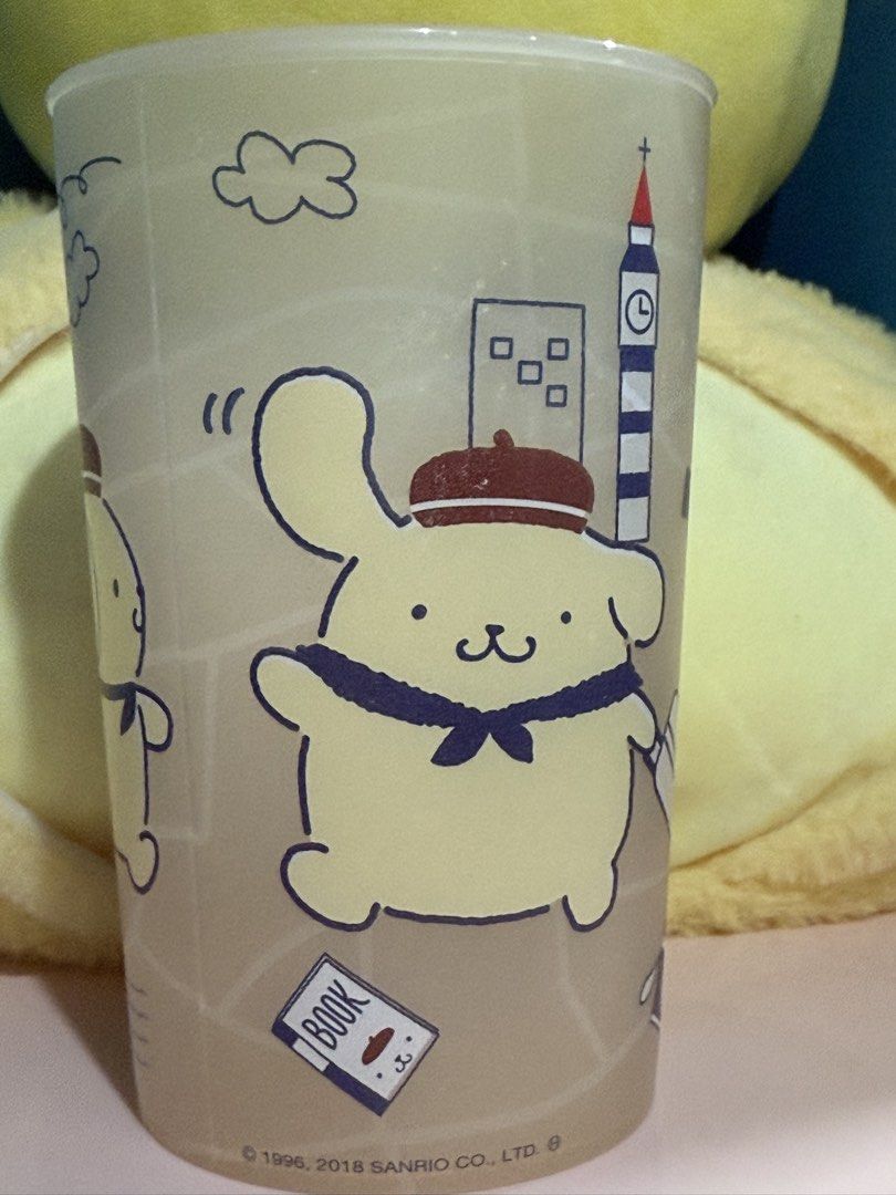 Sanrio Pompompurin plastic cup (Category: Water Bottles & Tumblers) located in Makati City. Submitted by karabelle19923 (Listing ID 1430659659, Image 2). Description: - Pompompurin plastic tumbler with travel-themed illustrations. - Features iconic landmarks and designs. - Official Sanrio licensed product. - Ideal for Pompompurin fans. - Cute and functional drinkware. Size: Approximately 8cm in diameter x 12cm in length Capacity…420ml Material…PP