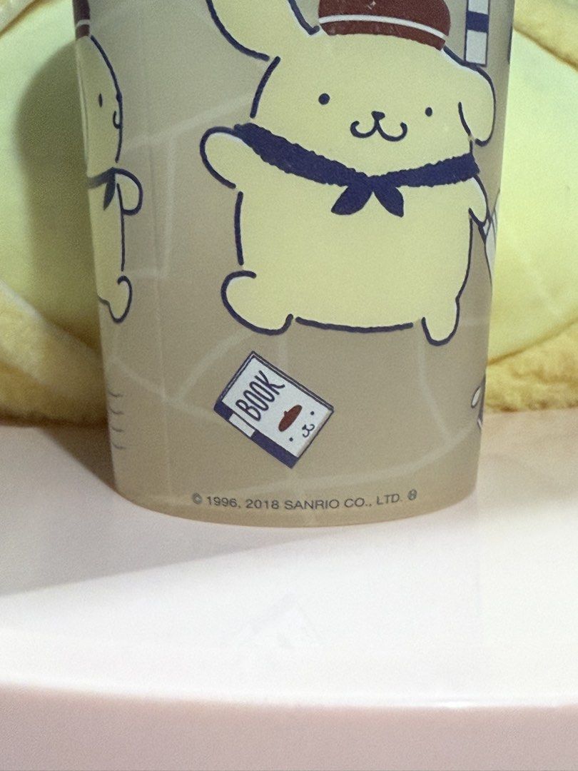 Sanrio Pompompurin plastic cup (Category: Water Bottles & Tumblers) located in Makati City. Submitted by karabelle19923 (Listing ID 1430659659, Image 3). Description: - Pompompurin plastic tumbler with travel-themed illustrations. - Features iconic landmarks and designs. - Official Sanrio licensed product. - Ideal for Pompompurin fans. - Cute and functional drinkware. Size: Approximately 8cm in diameter x 12cm in length Capacity…420ml Material…PP