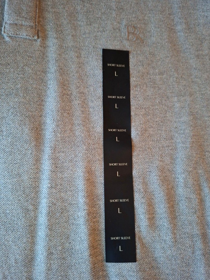Short Sleeve Polo Shirt - Size L (Category: Tshirts & Polo Shirts ) located in Mandaue City. Submitted by fsmfsm (Listing ID 1430618420, Image 2). Description: Short-sleeved polo shirt in a light gray color. It features a classic collar and a button-down placket. The shirt is a size L. The tag indicates it is a short sleeve shirt. - 28.5" x 22" - arm sleeve opening 7" -from US.