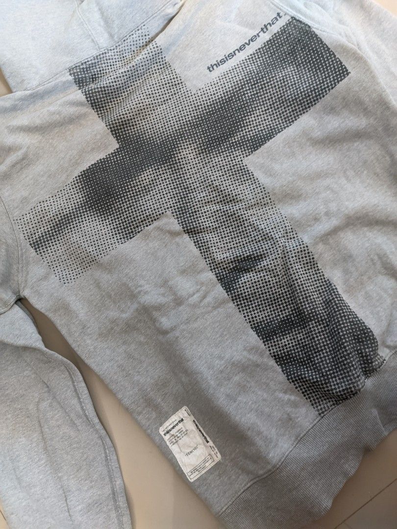 thisisneverthat Cross Ten (10) hoodie (Category: Hoodies) located in Gapan. Submitted by ukayukay9 (Listing ID 1430634492, Image 2). Description: Grey hoodie from thisisneverthat. It features a cross graphic on the back and the brand's logo on the front. The hoodie has a kangaroo pocket and a drawstring hood. The size is small. Made from 100% cotton..