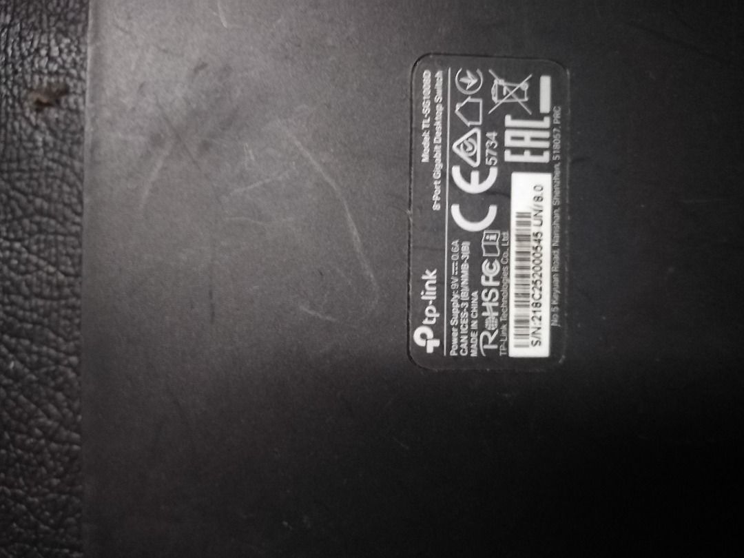 TP-Link 8-Port Gigabit Desktop Switch (Category: Networking) located in Manila. Submitted by maybonifacio (Listing ID 1430694630, Image 2). Description: TP-Link 8-Port Gigabit Desktop Switch. Model TL-SG1008D. Includes the switch and power adapter. The switch has a black finish. The device has some visible wear and tear. It is a network switch designed for connecting multiple devices to a network..