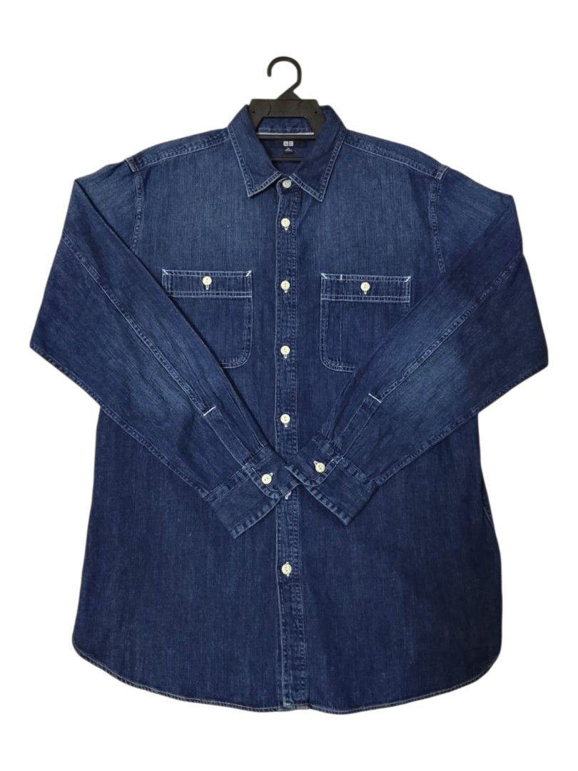 Uniqlo Denim Shirt XL (Category: Formal Shirts) located in Lunas. Submitted by znz_collections (Listing ID 1430604467, Image 1). Description: Uniqlo denim shirt in size XL. Features a classic button-down design with two chest pockets. The shirt is a dark blue denim color. Made in Bangladesh. The shirt has long sleeves and a standard collar. The tag indicates the shirt is a size XL. Size XL Pit to Pit : 24 inches Length : 30 inches.